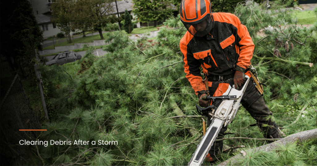man using chainsaw to clear debris
